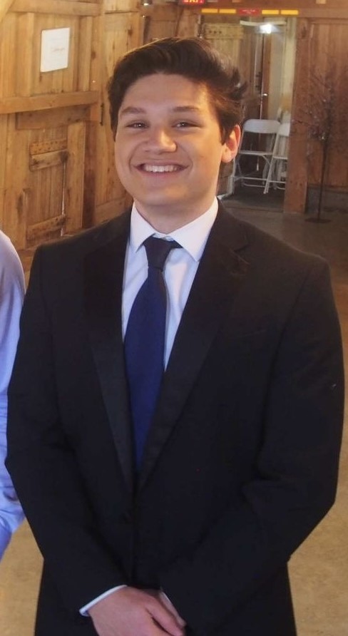 Photo of Justin Heath in a suit